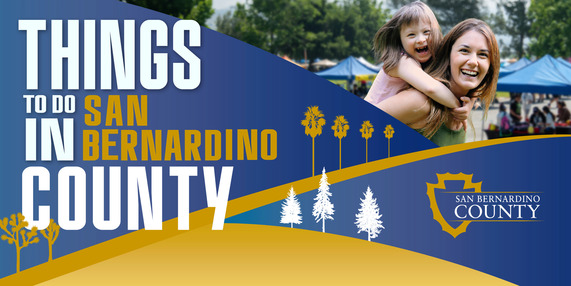 A banner reading “Things to Do in San Bernardino County” a woman and a laughing child enjoy a sunny day at an outdoor event. 