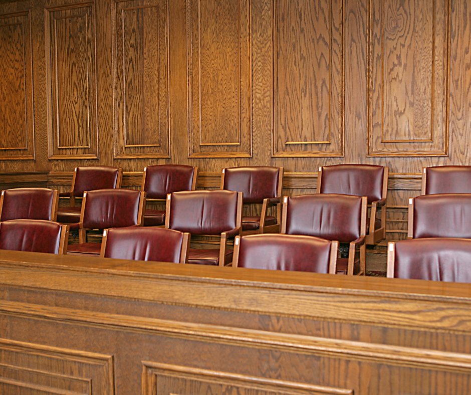 An empty jury box in a courtroom.