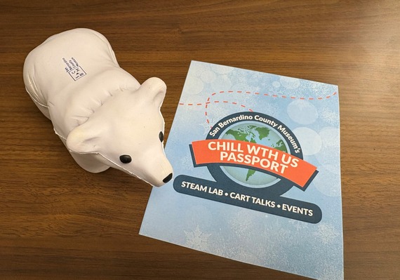 A white polar bear squeeze toy sits on a table showcasing the museum’s ‘Chill with Us’ summer passport.