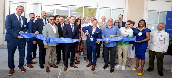 A group of local representatives participate in a ribbon-cutting ceremony to celebrate the unveiling of the new Adolescent Behavioral Health Unit.