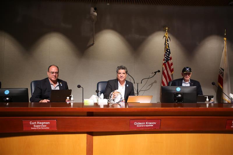 Curt Hagman, Gideon Kracov, and a colleague seated behind the dias during an AQMD public meeting.