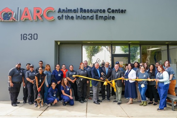 Group cuts ribbon at ARC grand opening in front of Animal Resource Center sign in Ontario.