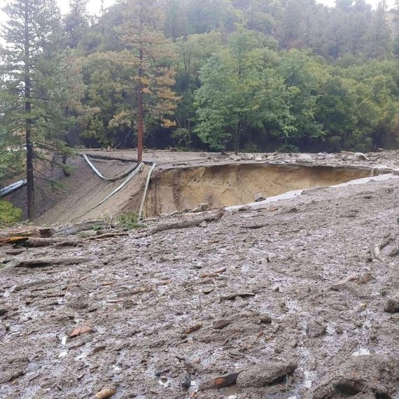 State Route 38 between Angelus Oaks and Big Bear, part of which is missing due to be washed away in storms. The rest of the road is covered in mud.