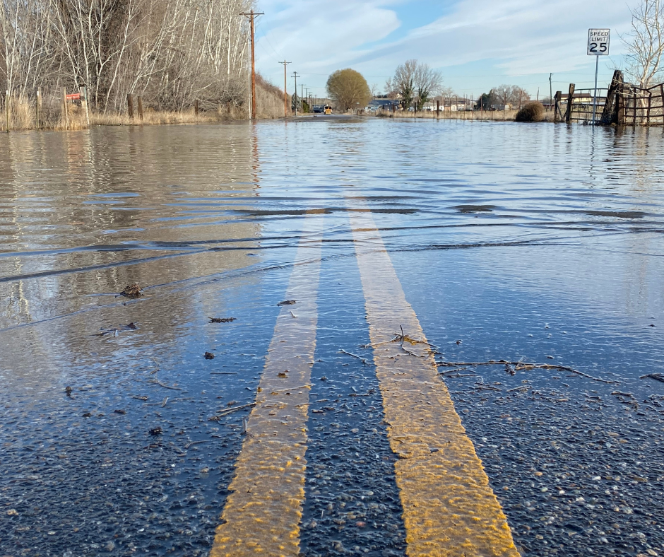 Flood waters cover a road in a rural portion of San Bernardino County