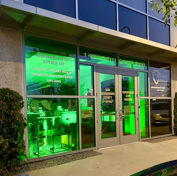 Fourth District Office building glows green at night for Operation Green Light.