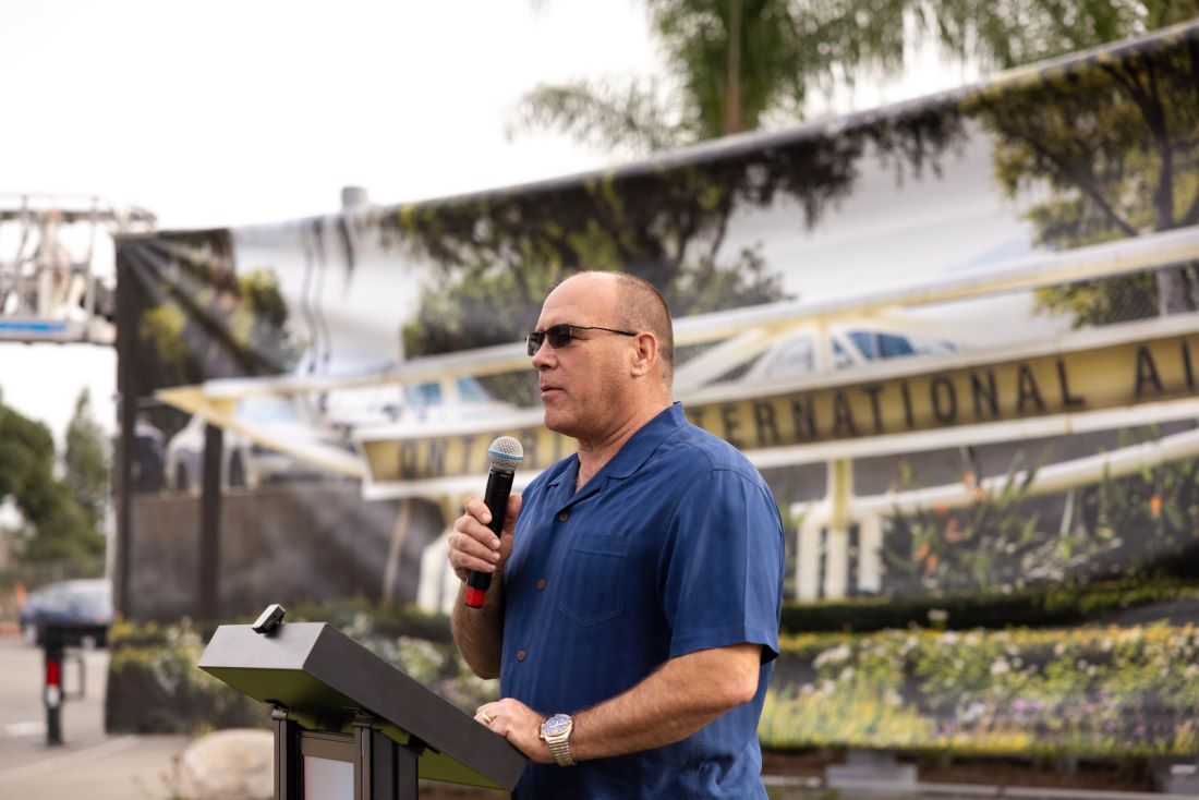 Supervisor Curt Hagman standing at a podium speaking at the ONT new monument unveiling. 