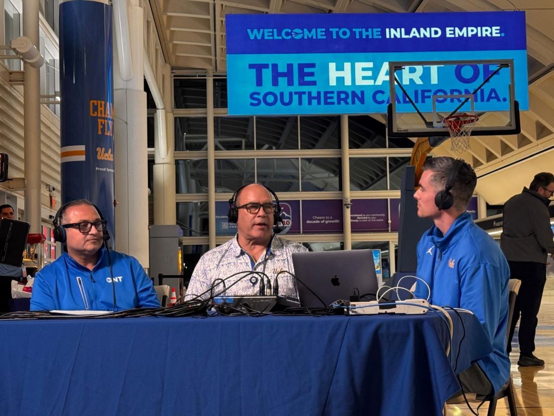 Radio interview setup in ONT Terminal 4 with a basketball hoop display for March Madness promotion. 