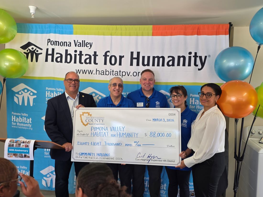 Supervisor Curt Hagman presents a $88,000 check to Pomona Valley Habitat for Humanity team.