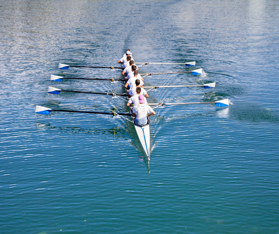 An 8 man team rowing crew out on the water, doing what they do best.