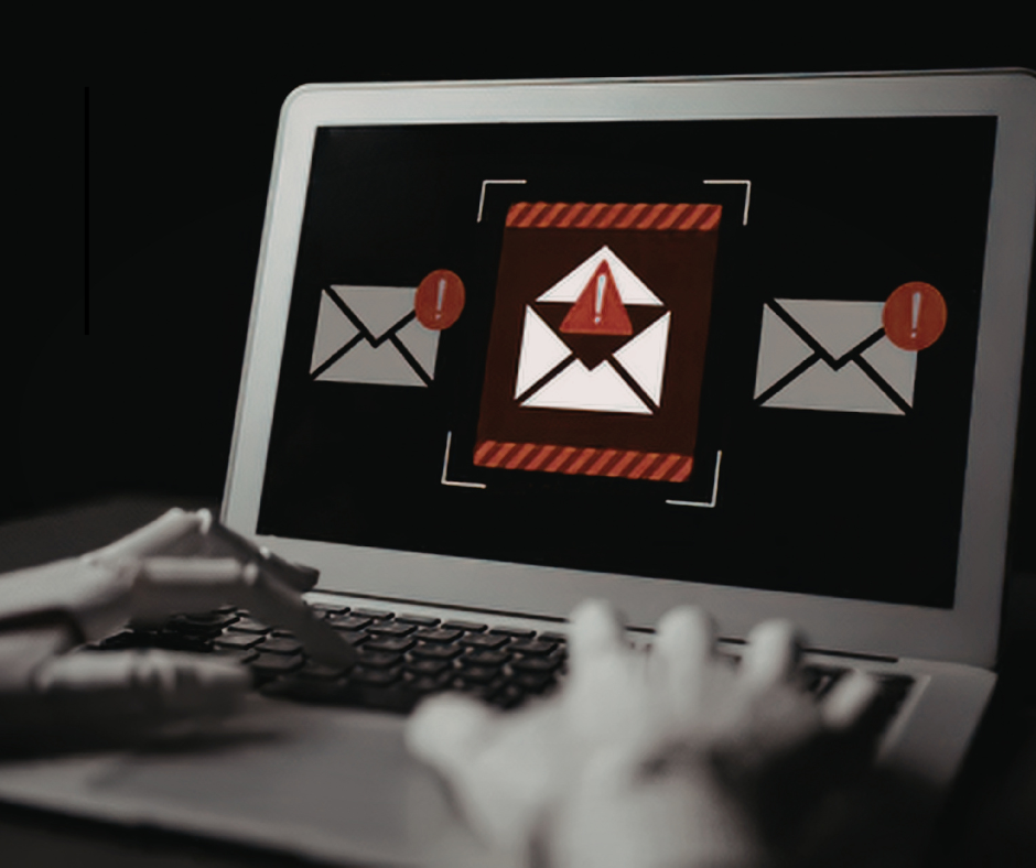 laptop screen displays warning icons over email envelopes, and a red alert symbol, while hands type on the keyboard