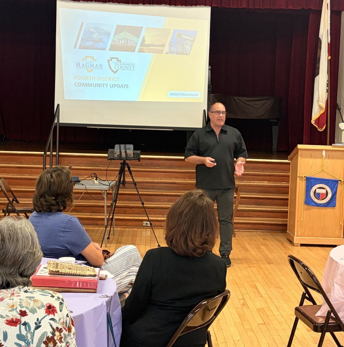 Supervisor Curt Hagman speaks during a Fourth District Community Update presentation as the Upland Women's Club members listen in a community hall.