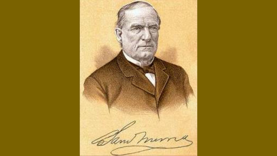 An individual wearing a formal suit with a bow tie and a signature against a darker and lighter warm brown background. 