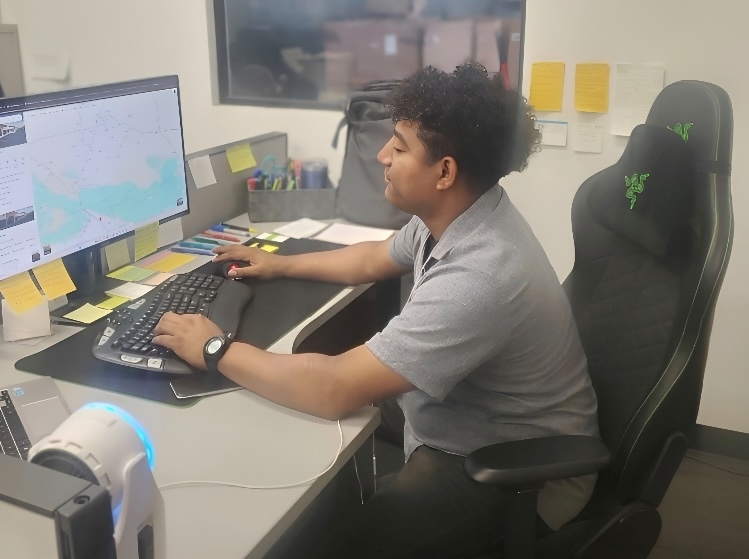 Derek Flores at his desk