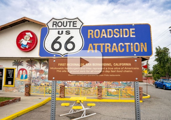Route 66 roadside attraction sign at the original McDonald’s site in San Bernardino, featuring history of its hamburgers and fries.