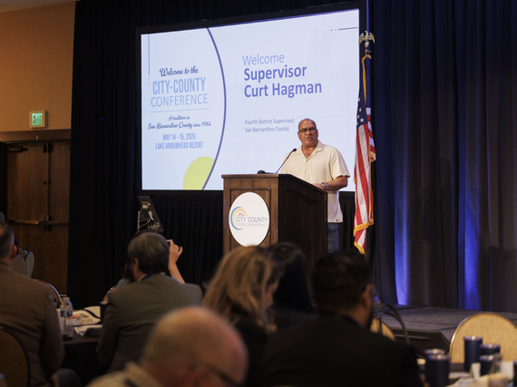 Supervisor Hagman speaking on stage behind a podium at the 2026 City County Conference in Lake Arrowhead.