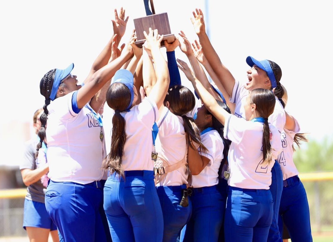 Needles High School LadyStangs softball team lift the Nevada 2A State Championship trophy following their championship victory.