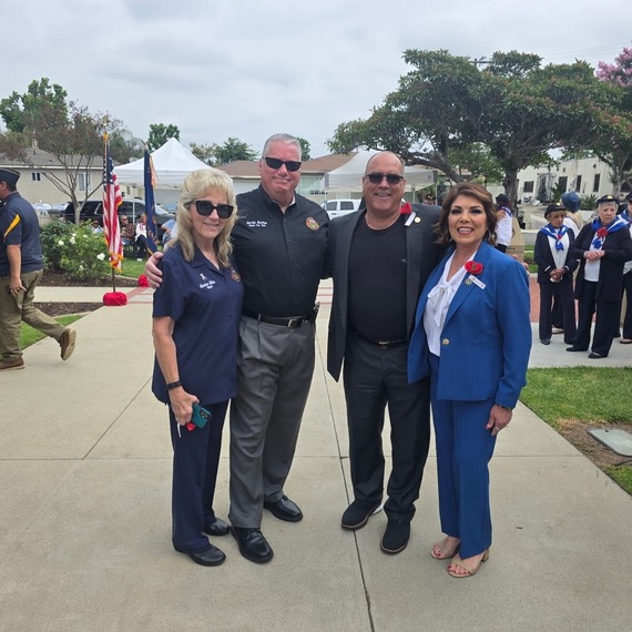 Four attendees pose together during the City of Chino Memorial Day event honoring fallen service members and veterans.