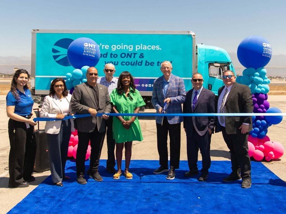 Officials celebrate the ribbon-cutting of Ontario International Airport’s new zero-emission electric truck.