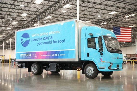 Ontario International Airport’s first electric fleet truck displayed inside a warehouse with airport branding.