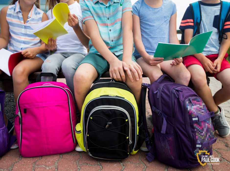 Children holding backpacks