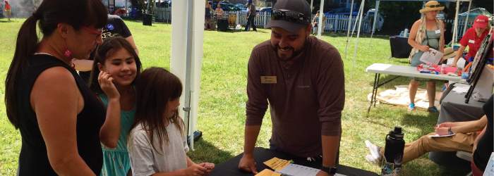 Neighbors gathered around table at Neighborfest event