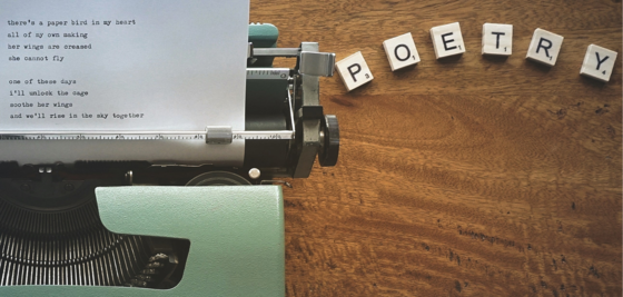 Poetry graphic with typewriter and Scrabble letters