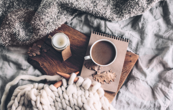 Warm drinks on a cozy bed with a winter vibe