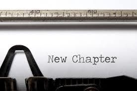typewriter with the words "new chapter" on the page