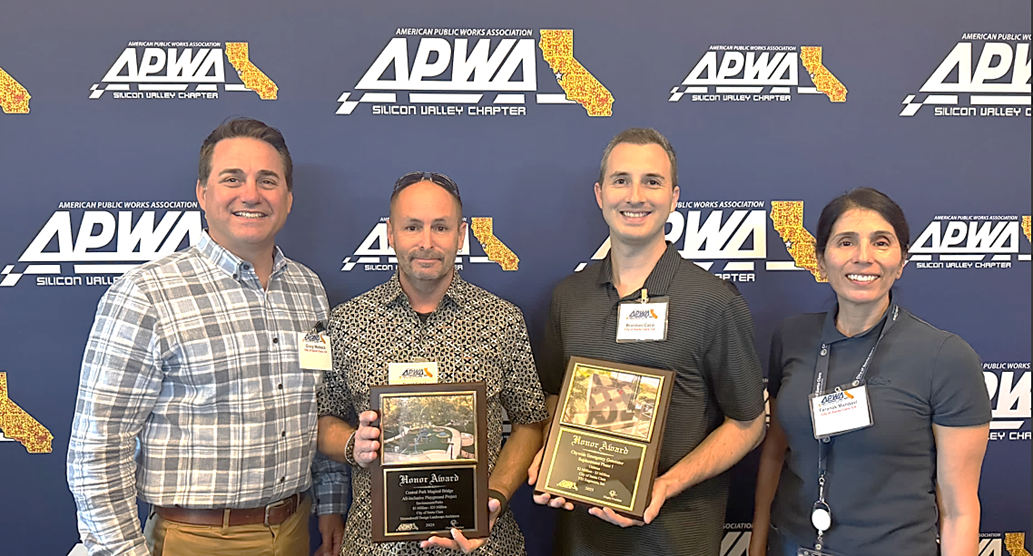 Department of Public Works staff holding plaques for the two APWA Awards the department won. 