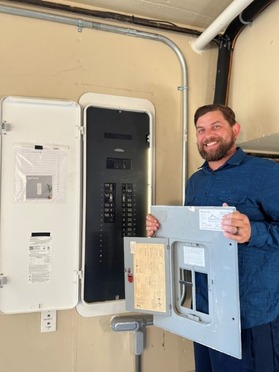 Person standing in front of an electric panel