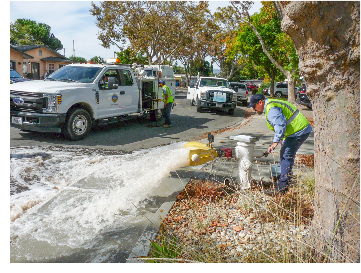Staff opening hydrant to flush water main
