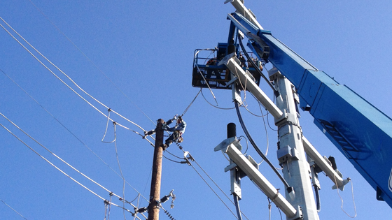Lineman working on electrical pole