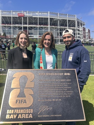 Mayor Gillmor with City Staff posing with a FIFA plaque 