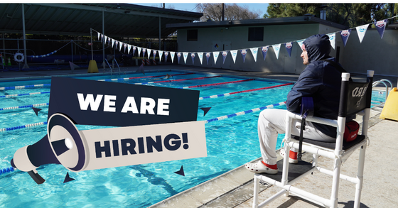 A bundled-up lifeguard watching over swimming lanes while a We Are Hiring message appears in front.