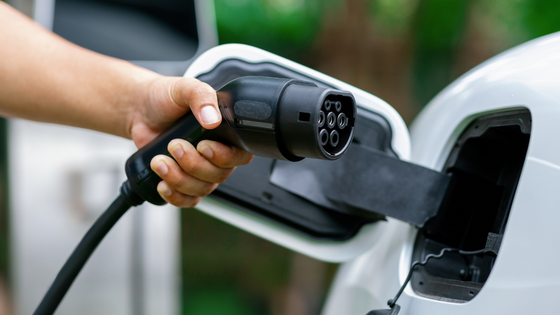 Person plugging in their EV