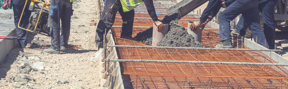 Construction workers pouring concrete