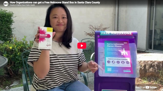 Woman holding a naloxone box