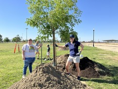 Community members planting a tree