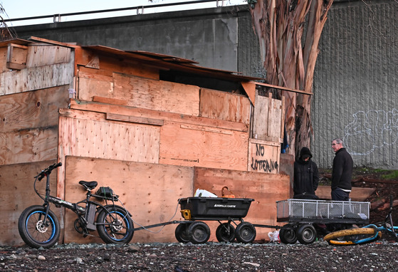 Mike Callagy walks an encampment