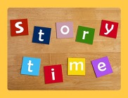 letter blocks spelling out storytime on a wood background