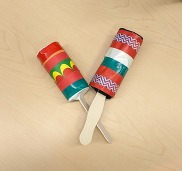 maraca craft made from toilet paper tubes, wood sticks and colorful tape