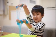 child playing with blue slime