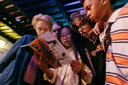 children looking at a comic book together
