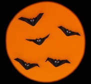 Origami bats on an orange background