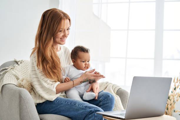 woman and baby in front of a laptop