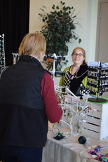 Shopper choosing from an array of crafted jewelry 