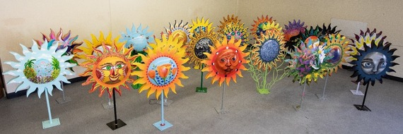 26 colorful metal sun sculptures on 5 foot stands