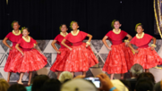 group of hula dancers performing on stage