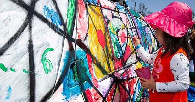young girl painting a van