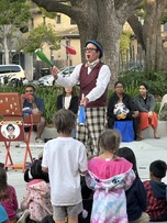 Performer at Thursday Night in the Park juggling bowling pins. 